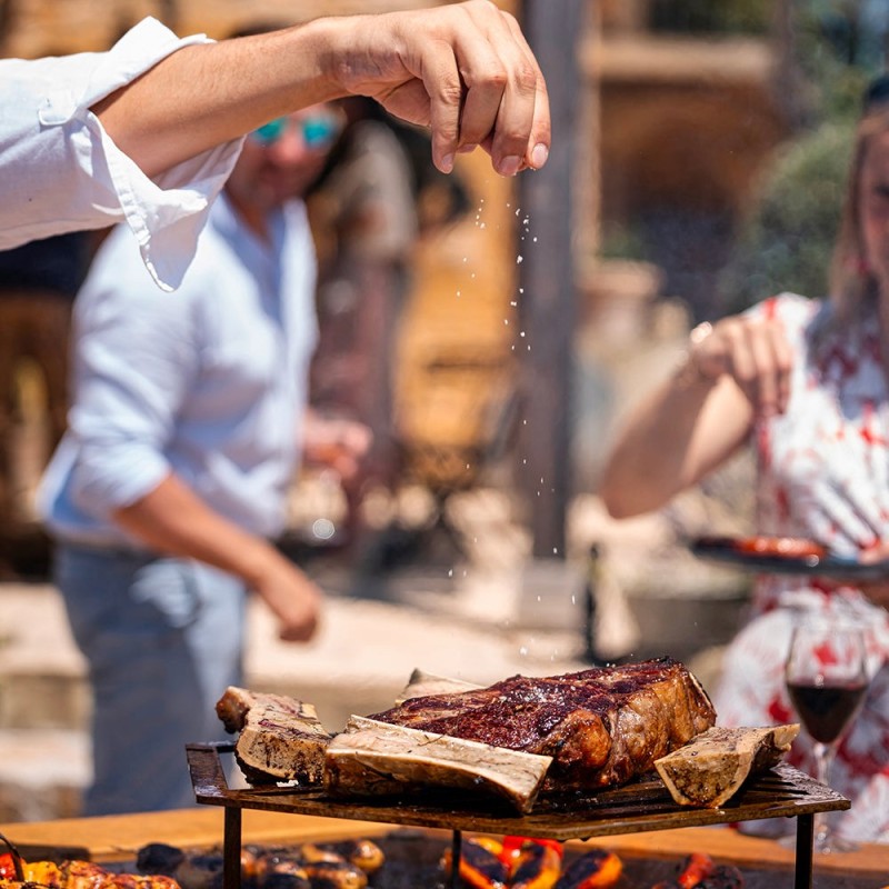 grille plinthe pour brasero 150cm en inox - cuisson surélevée au centre du barbecue (exemple de mise en situation)